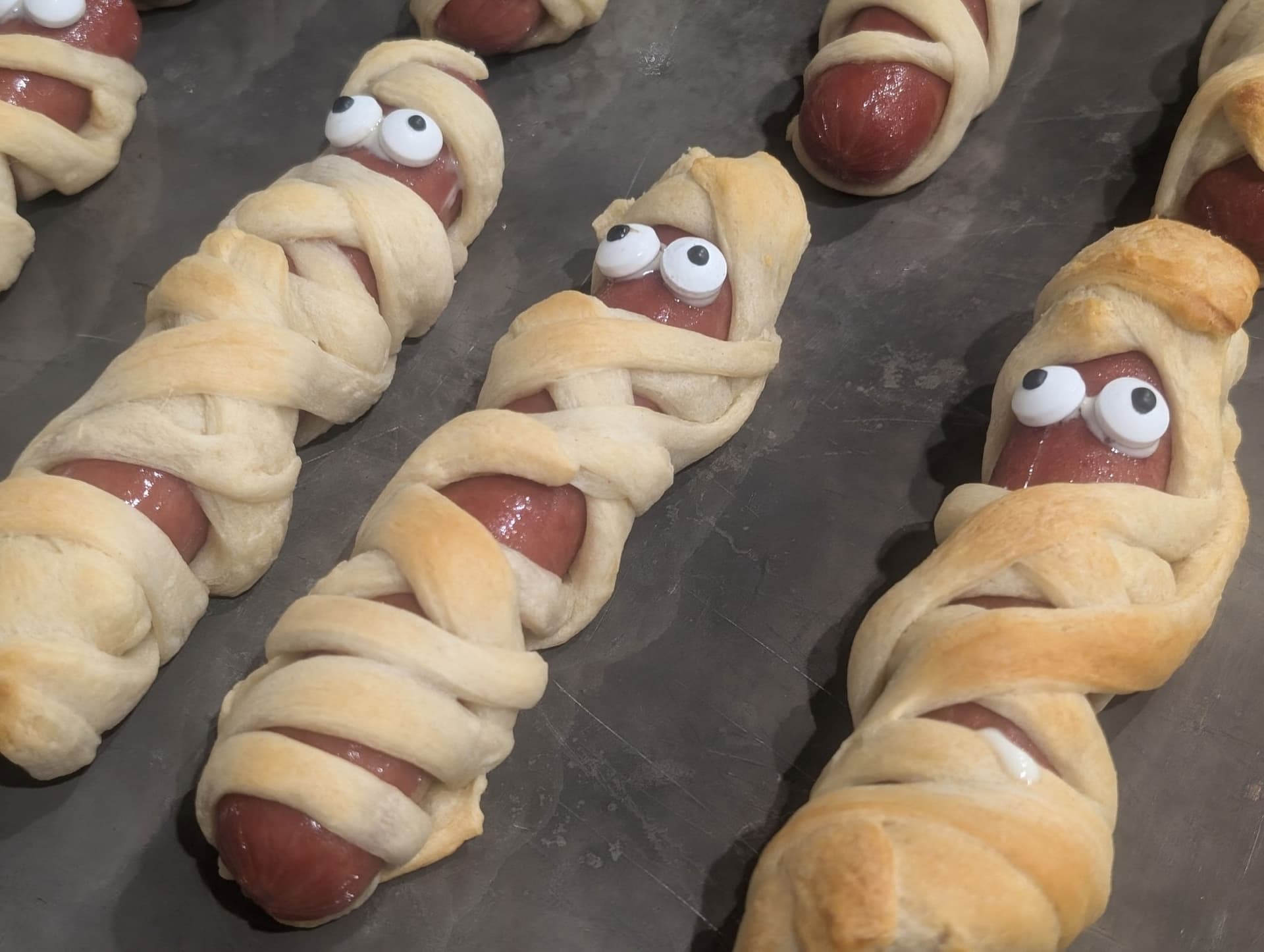 Halloween Mummy Dogs with Crescent Roll Wraps and Candy Eyes