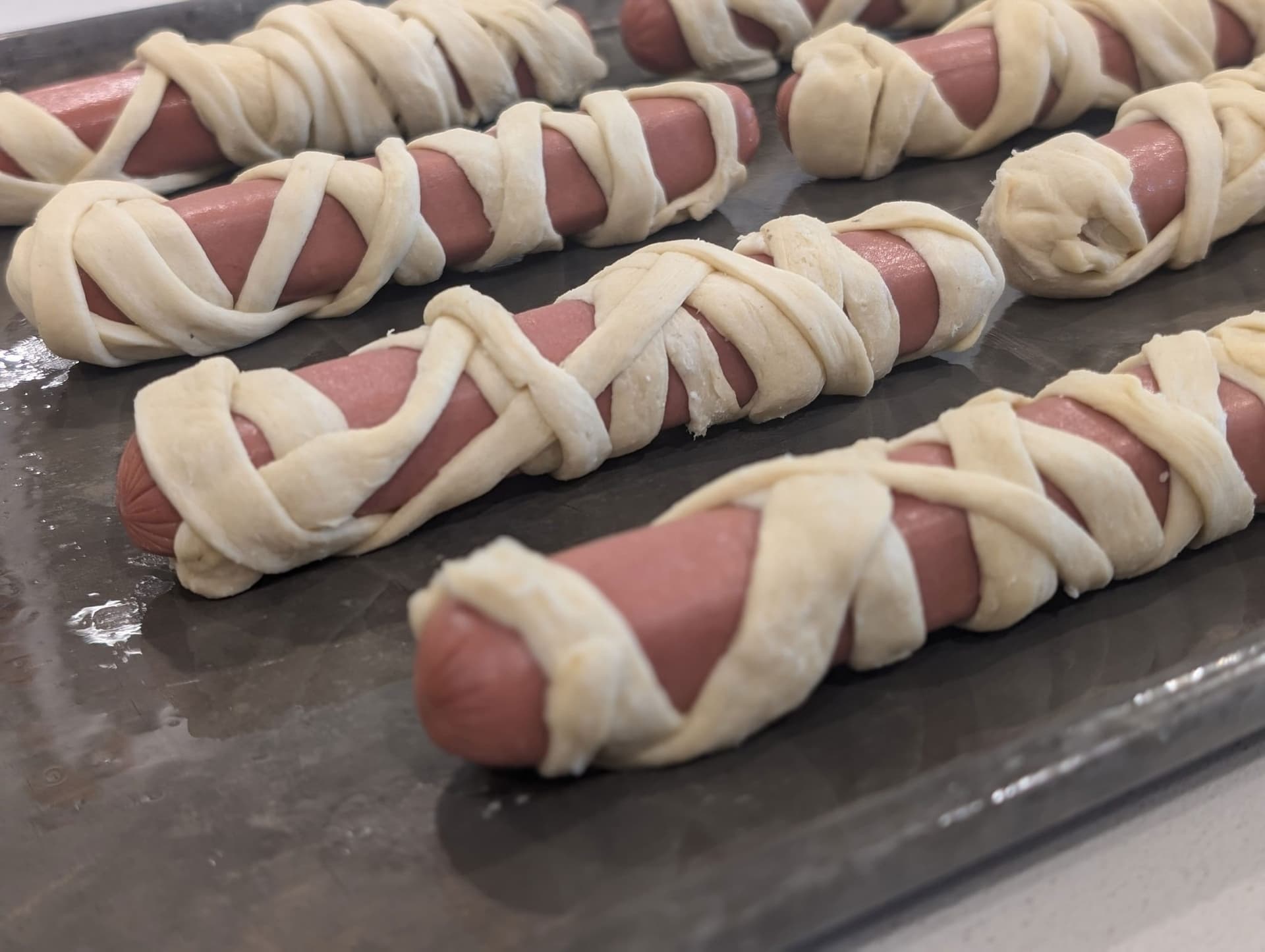 Halloween Mummy Dogs with Crescent Roll Wraps and Candy Eyes