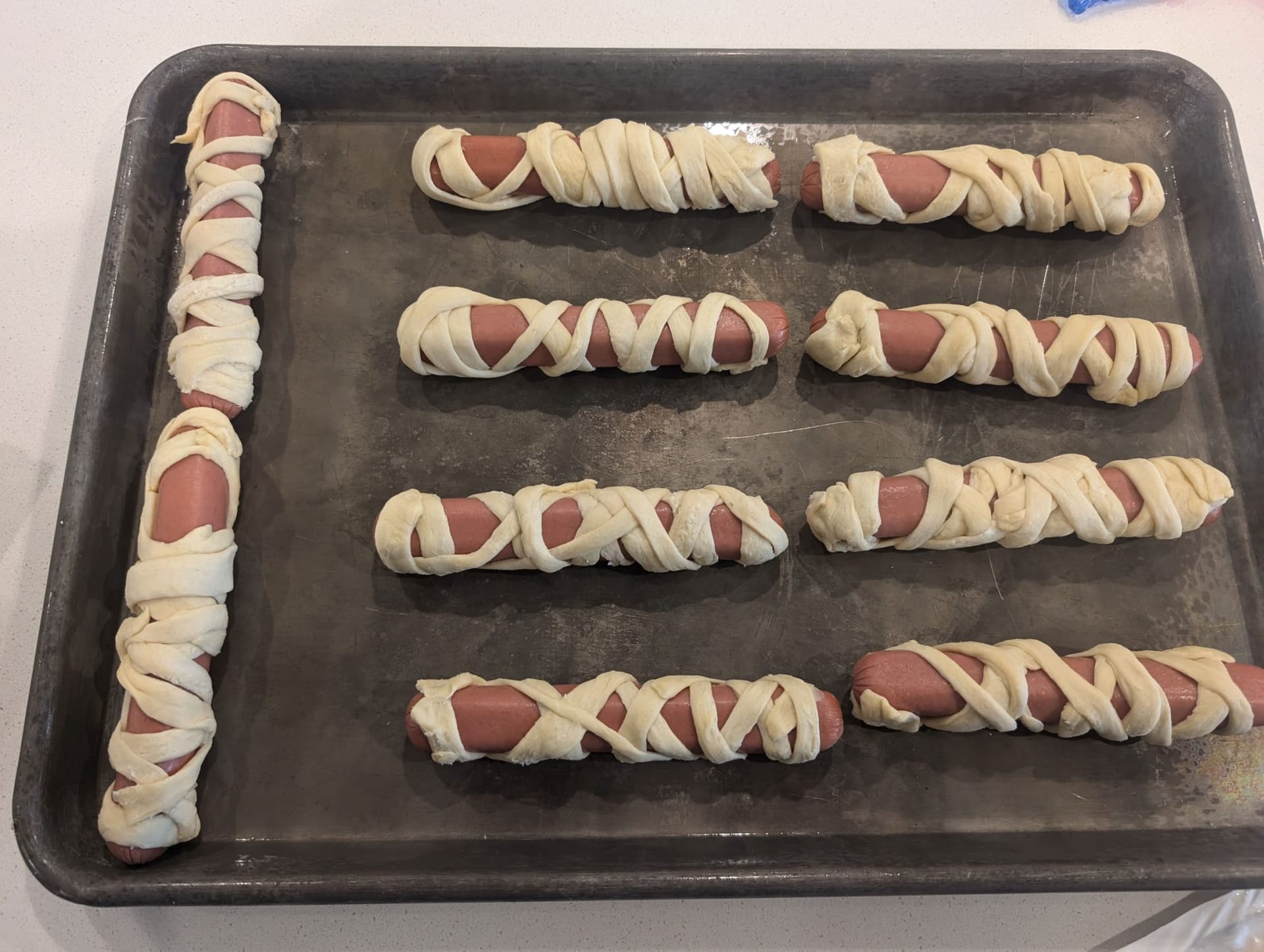Halloween Mummy Dogs with Crescent Roll Wraps and Candy Eyes